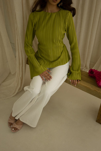 Girl wearing a pleated, asymmetrical cut summer top