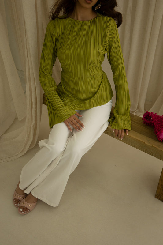 Girl wearing a pleated, asymmetrical cut summer top